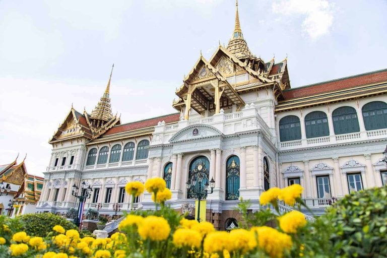 Bangkok's Grand Palace With Beautiful Yellow Flower In Front