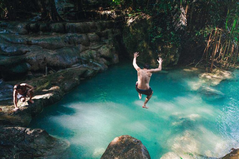 Man Jumping Into A Natural Pond