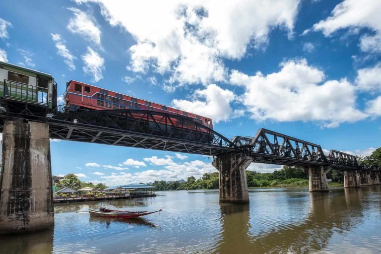 Low Angle Train Running On Histotic Railway Of River Kwai Bridge