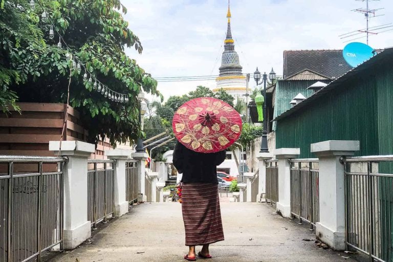 Lady Holding The Red Paper Umbrella Walking In On The Bridge In Chiang Mai