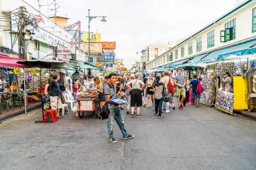 Tourists and locals walk along popular backpacker destination Khao San Road. The area is famous for its street market in Thailand.